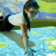 Girl in Sensory Room using Interactive Floor Projection
