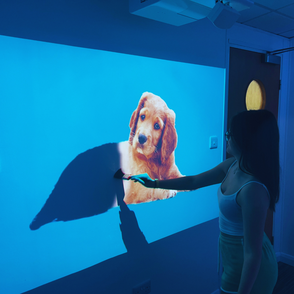 Children interacting with omiReflex sensory wall projection for special needs and autism